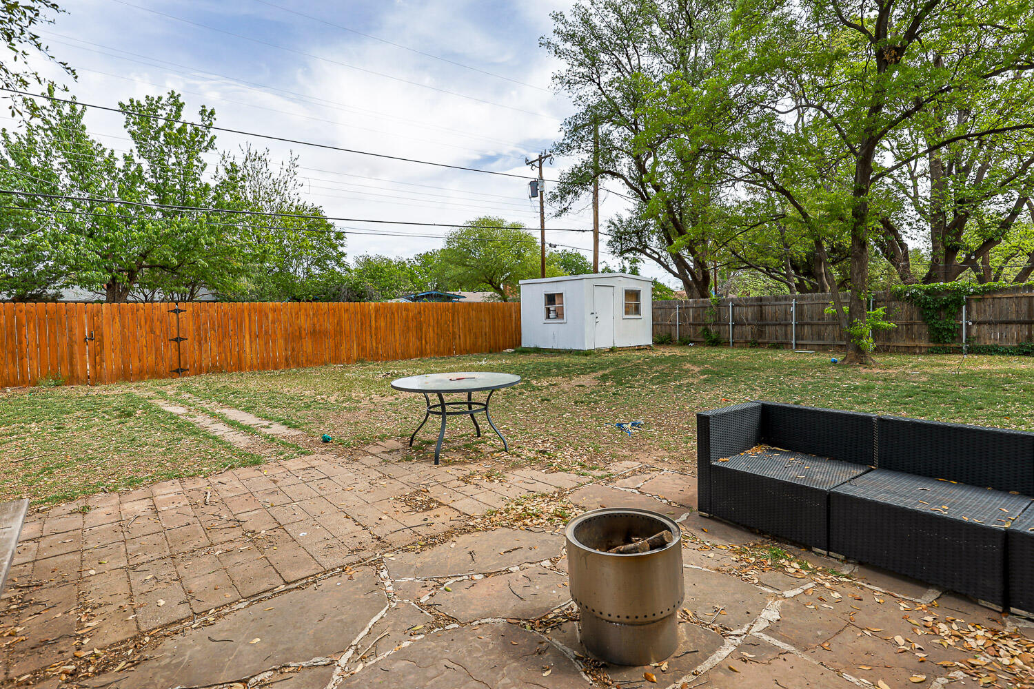 2718 55th Street Lubbock, TX 79413 - Photo 53 of 58 a view of a chairs and table in backyard of the house