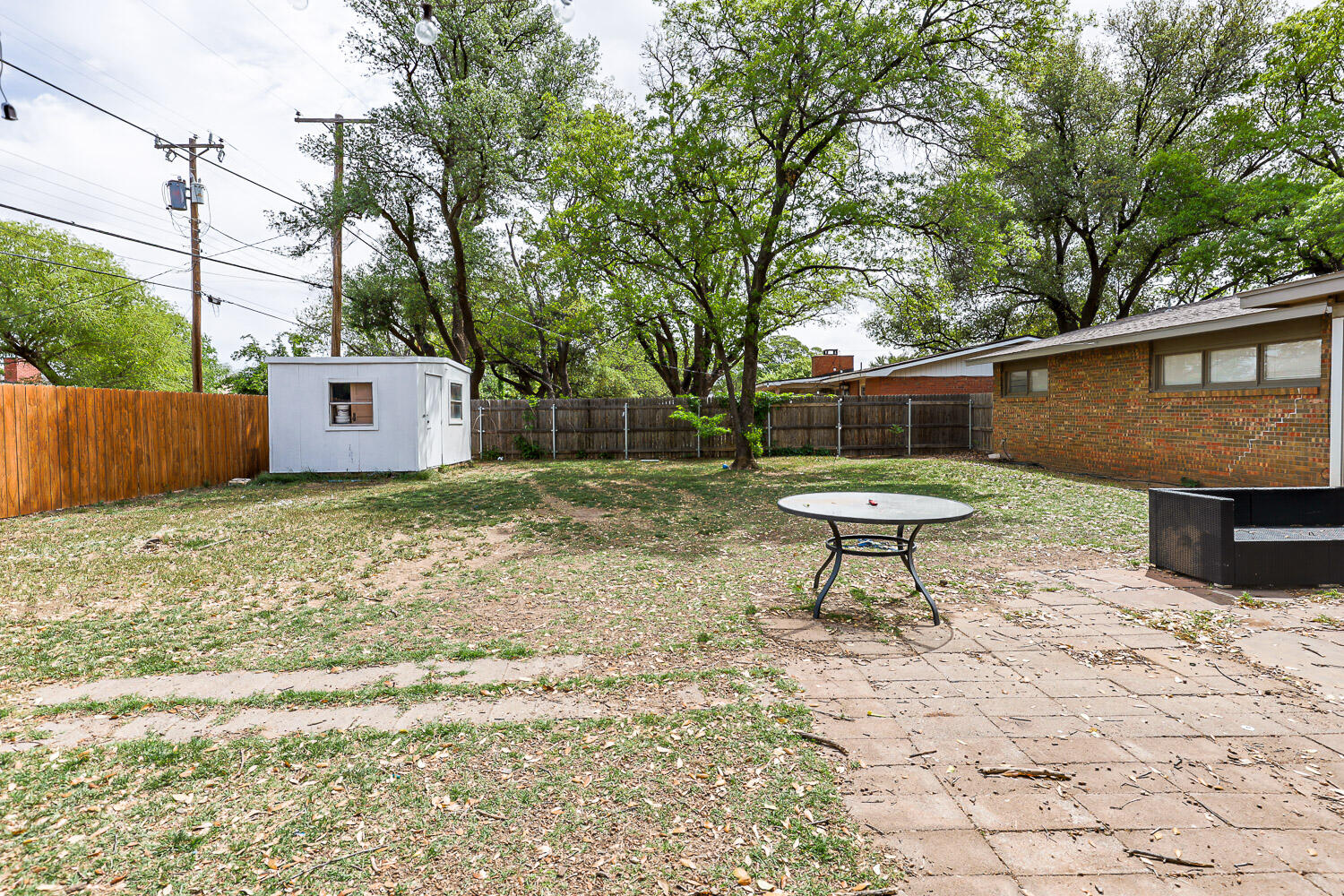 2718 55th Street Lubbock, TX 79413 - Photo 55 of 58 a house view with a bench in the patio