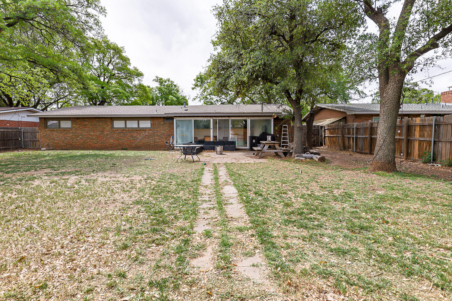 2718 55th Street Lubbock, TX 79413 - Photo 56 of 58 front view of a house with yard and trees