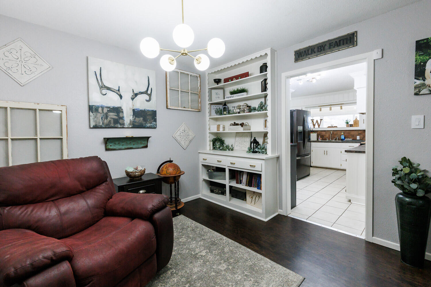 2718 55th Street Lubbock, TX 79413 - Photo 9 of 58 a living room with furniture a chandelier and kitchen view