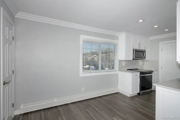 a kitchen with granite countertop a stove and a refrigerator