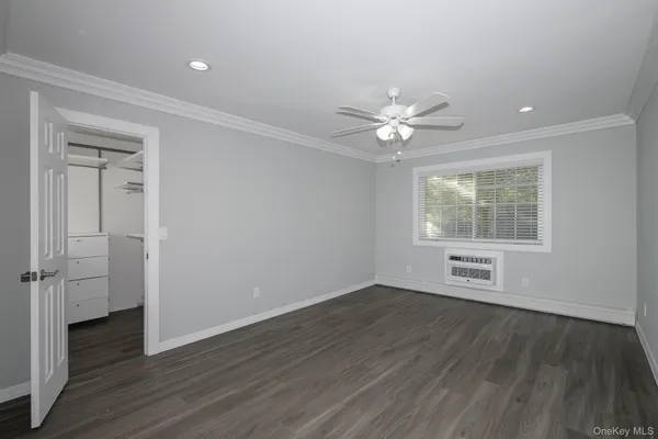 an empty room with wooden floor and a window