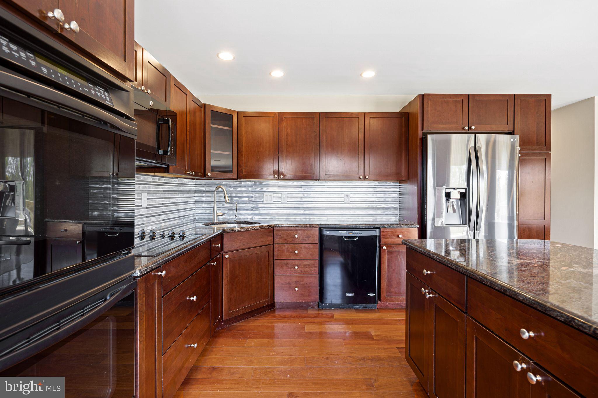 883 Echo Hill Road West Chester, PA 19382 - Photo 11 of 50 Modern kitchen with rich wood cabinetry.