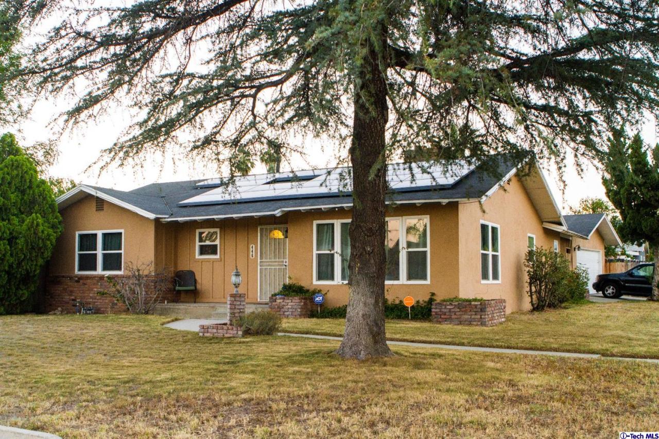 446 East Jackson Street Rialto, CA 92376 - Photo 2 of 6 a front view of a house with garden and trees