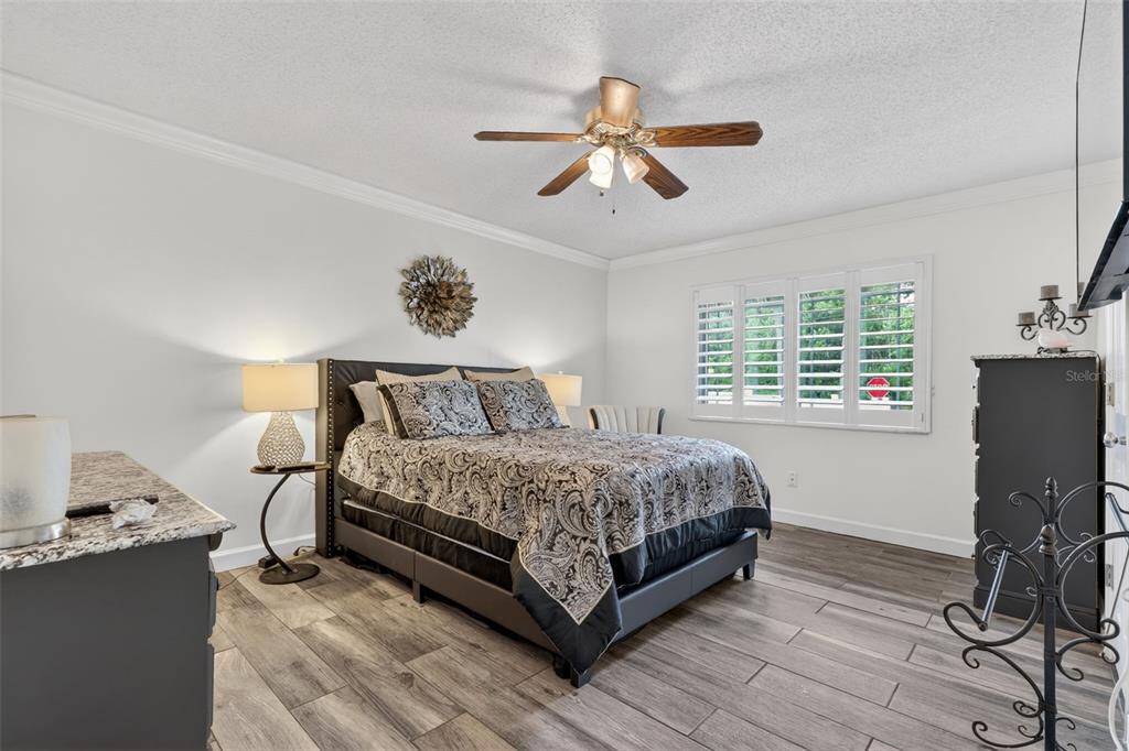 575 Tiberon Cove Road Longwood, FL 32750 - Photo 31 of 56 a bedroom with a bed and dresser with wooden floor