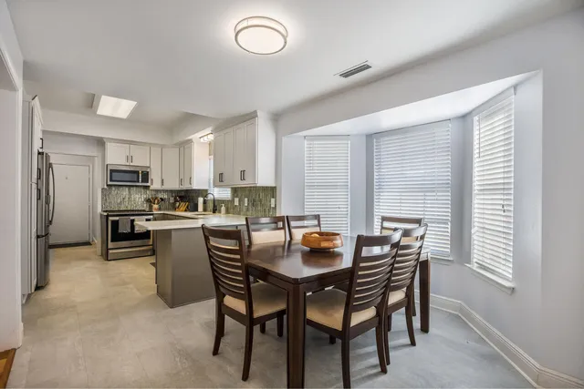 a kitchen with a table and chairs in it