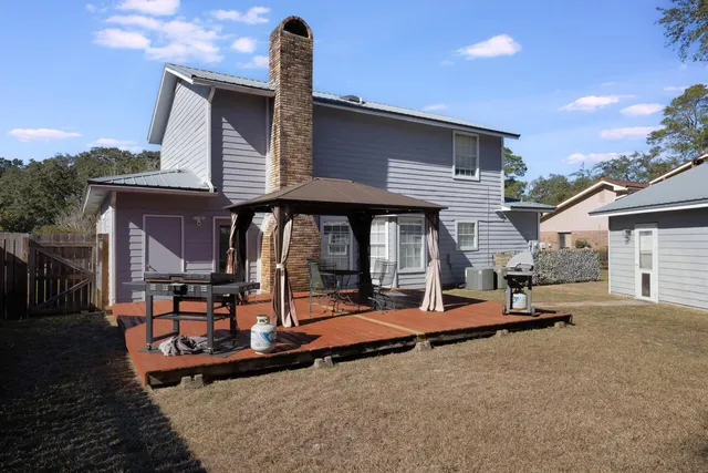 a backyard of a house with basket ball court and outdoor view
