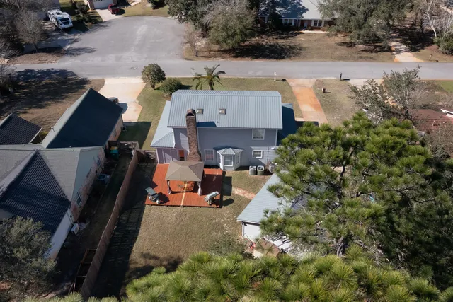 an aerial view of a house with a yard