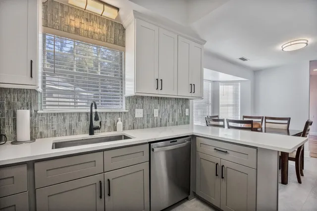 a kitchen with refrigerator and cabinets