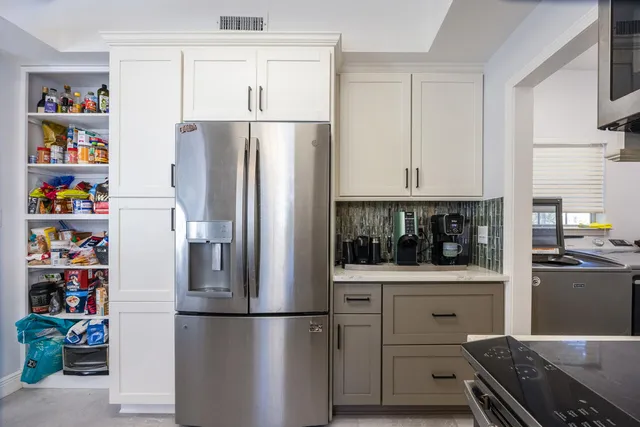 a kitchen with a sink cabinets and window