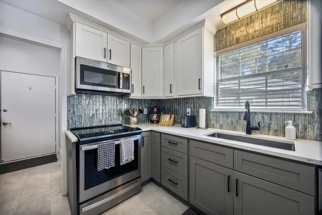 a kitchen with stainless steel appliances a refrigerator and a stove top oven