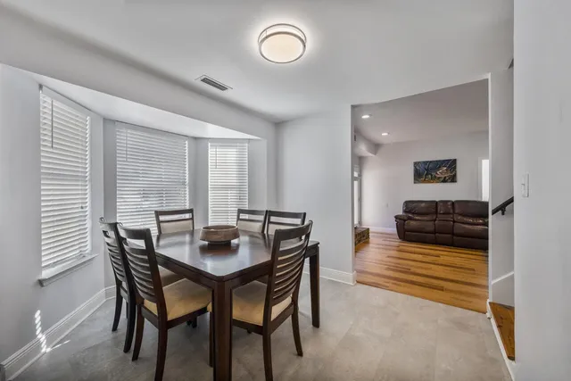 a kitchen with stainless steel appliances granite countertop white cabinets a sink and a stove