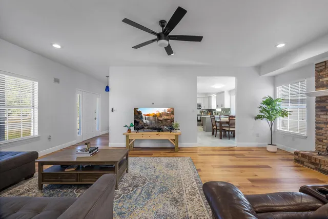 a living room with furniture and a wooden floor
