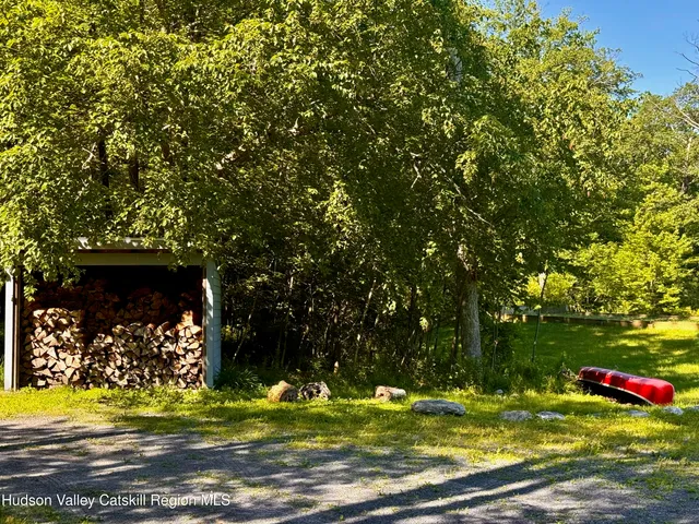 a view of a golf ground with large trees