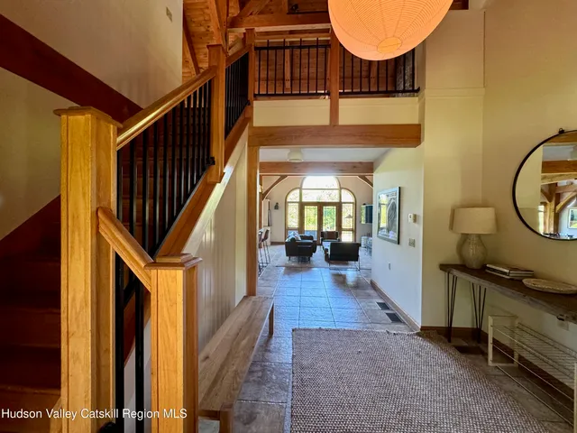 a view of entryway and hall with wooden floor