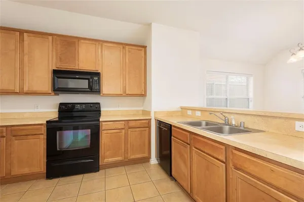 a kitchen with a sink stove and microwave
