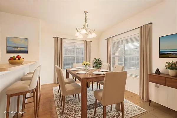 a dining room with furniture a chandelier and wooden floor