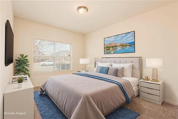 a bedroom with a large bed and a window