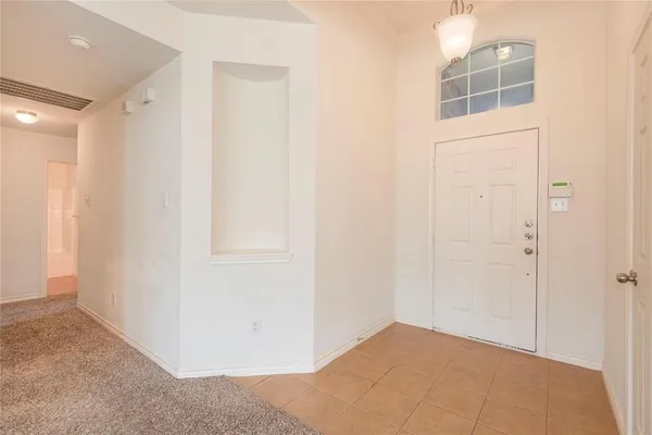 a view of a big room with closet and windows