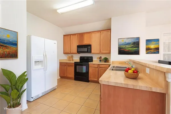 a kitchen with a refrigerator and a sink