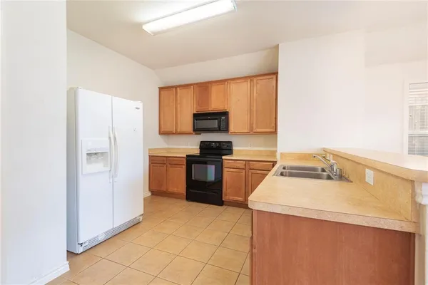 a kitchen with a refrigerator stove and a sink