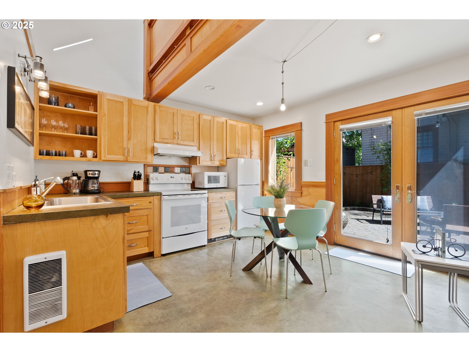 1912 Northeast 11th Avenue Portland, OR 97212 - Photo 29 of 41 a kitchen with a table chairs microwave and cabinets