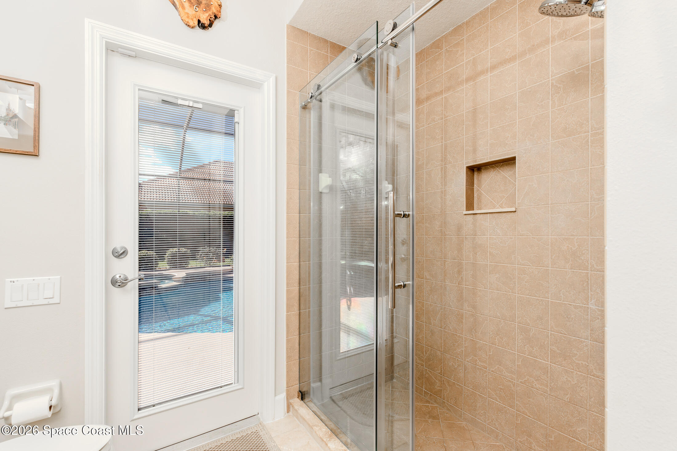 8201 Compton Way Melbourne, FL 32940 - Photo 22 of 52 a bathroom with a shower and a glass door