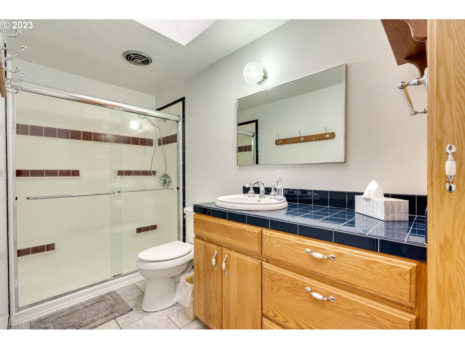 23728 South Springwater Road Estacada, OR 97023 - Photo 23 of 31 a bathroom with a granite countertop sink mirror vanity and toilet