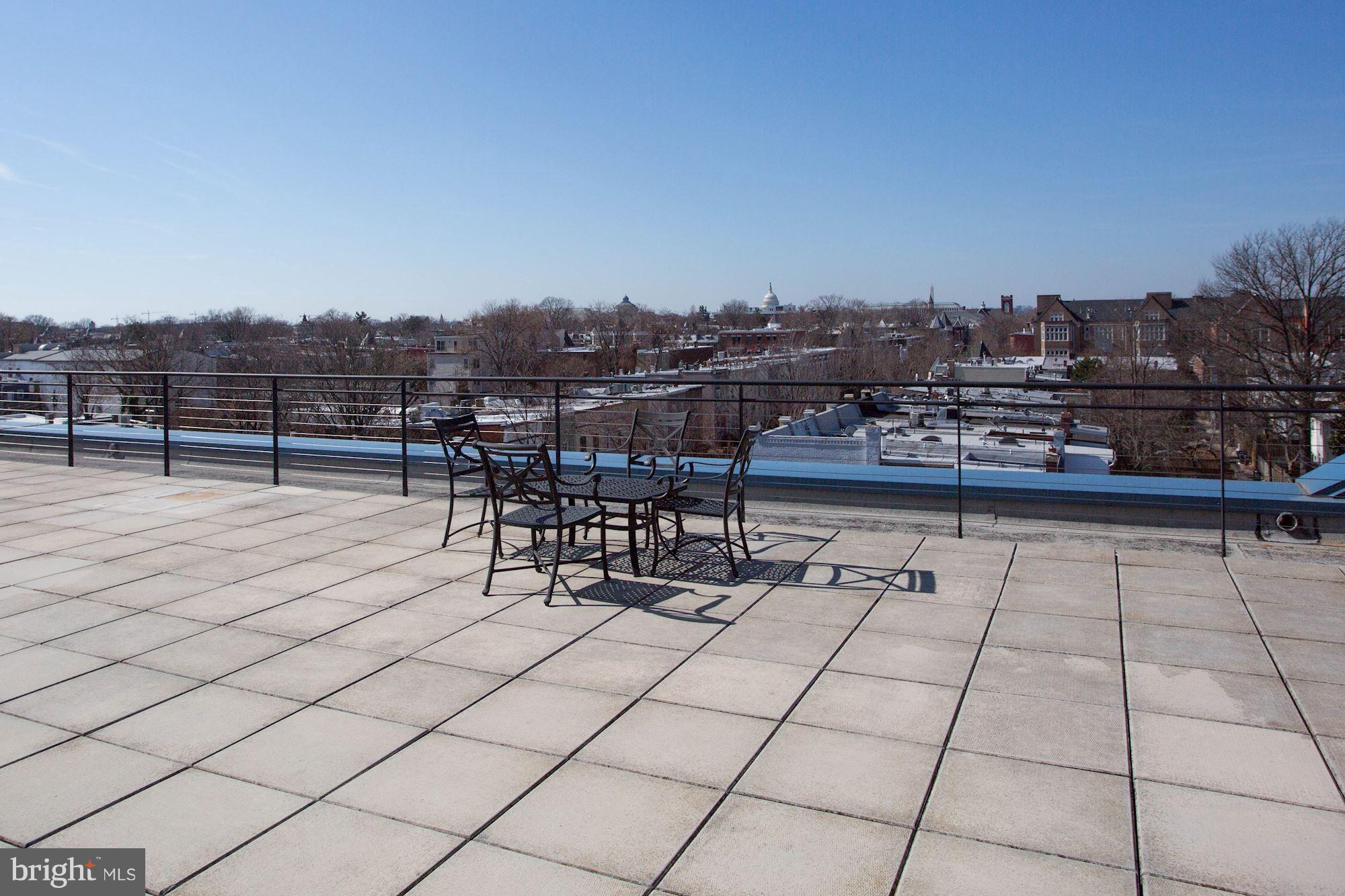 401 13th Street Northeast, Unit 408 Washington, DC 20002 - Photo 19 of 30 Rooftop deck with grill, tables and chairs
