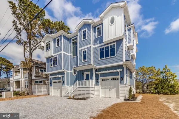 a view of staircase with wooden floor and white walls