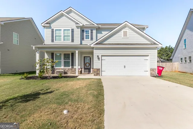 a front view of a house with garden