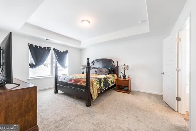 a bedroom with a bed and a flat tv screen