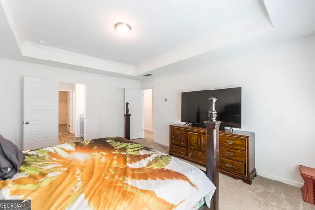 a bedroom with a bed and flat screen tv