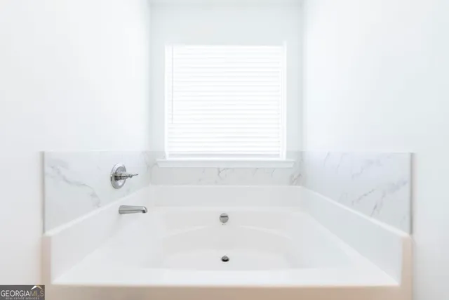 a white bath tub sitting next to a window