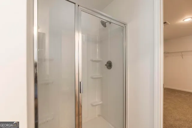 a bathroom with a glass shower door