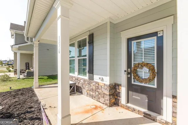 a view of a porch with a table and chairs