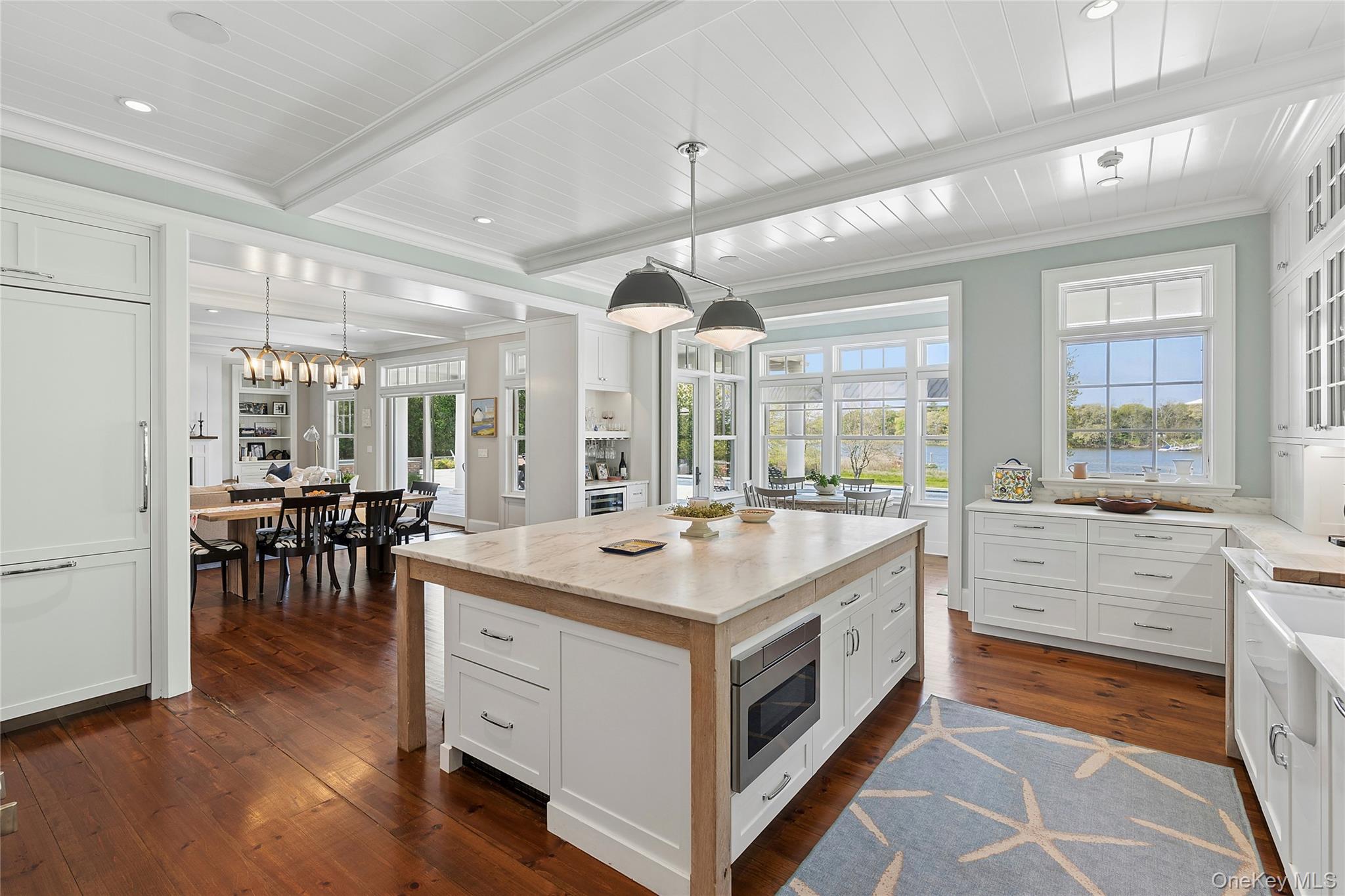 43 Old Main Road Quogue, NY 11959 - Photo 6 of 28 a large white kitchen with a large window