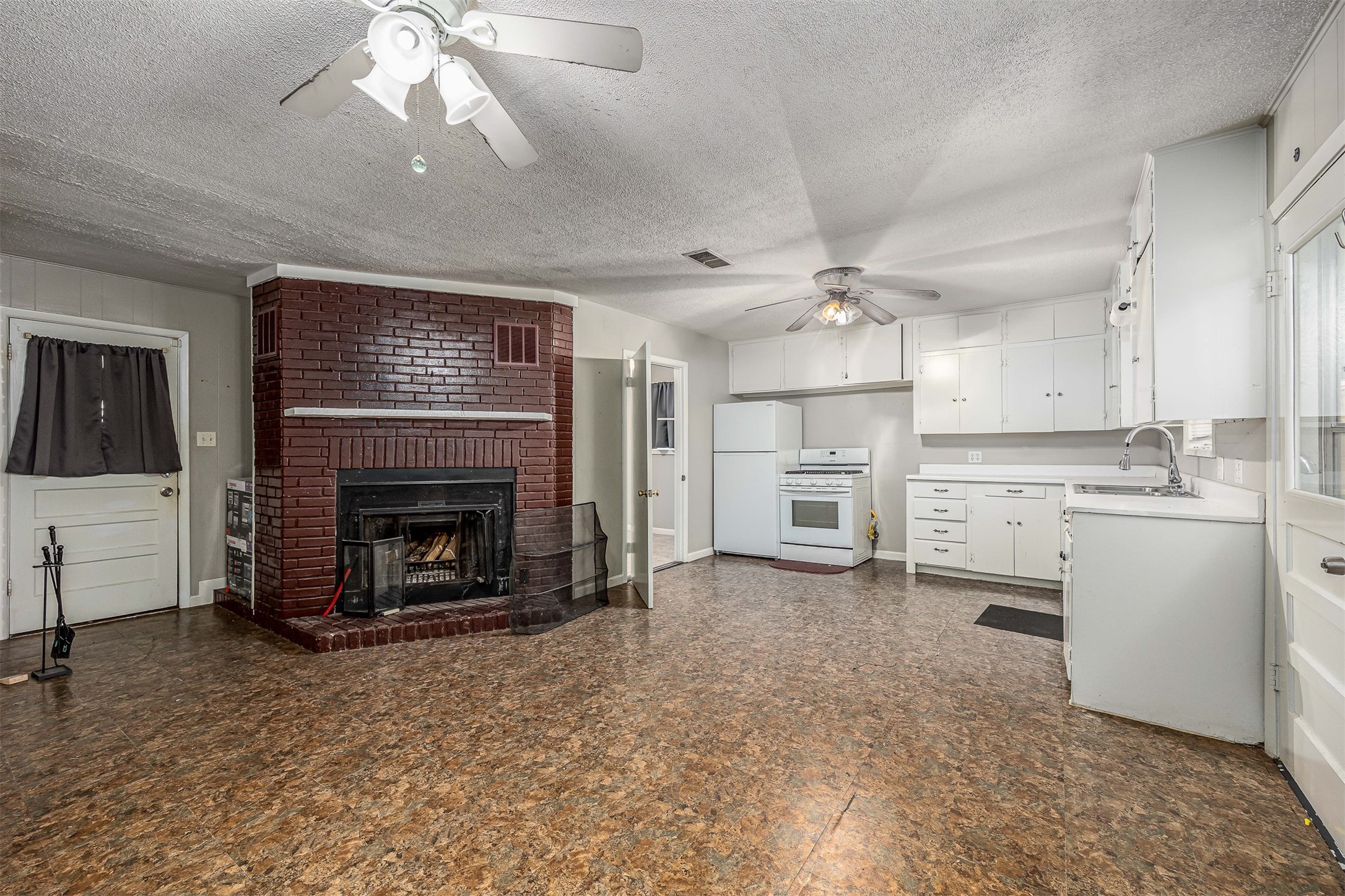 502 Massey Tompkins Road Baytown, TX 77521 - Photo 32 of 32 a view of a livingroom with a fireplace a sink and dishwasher kitchen view