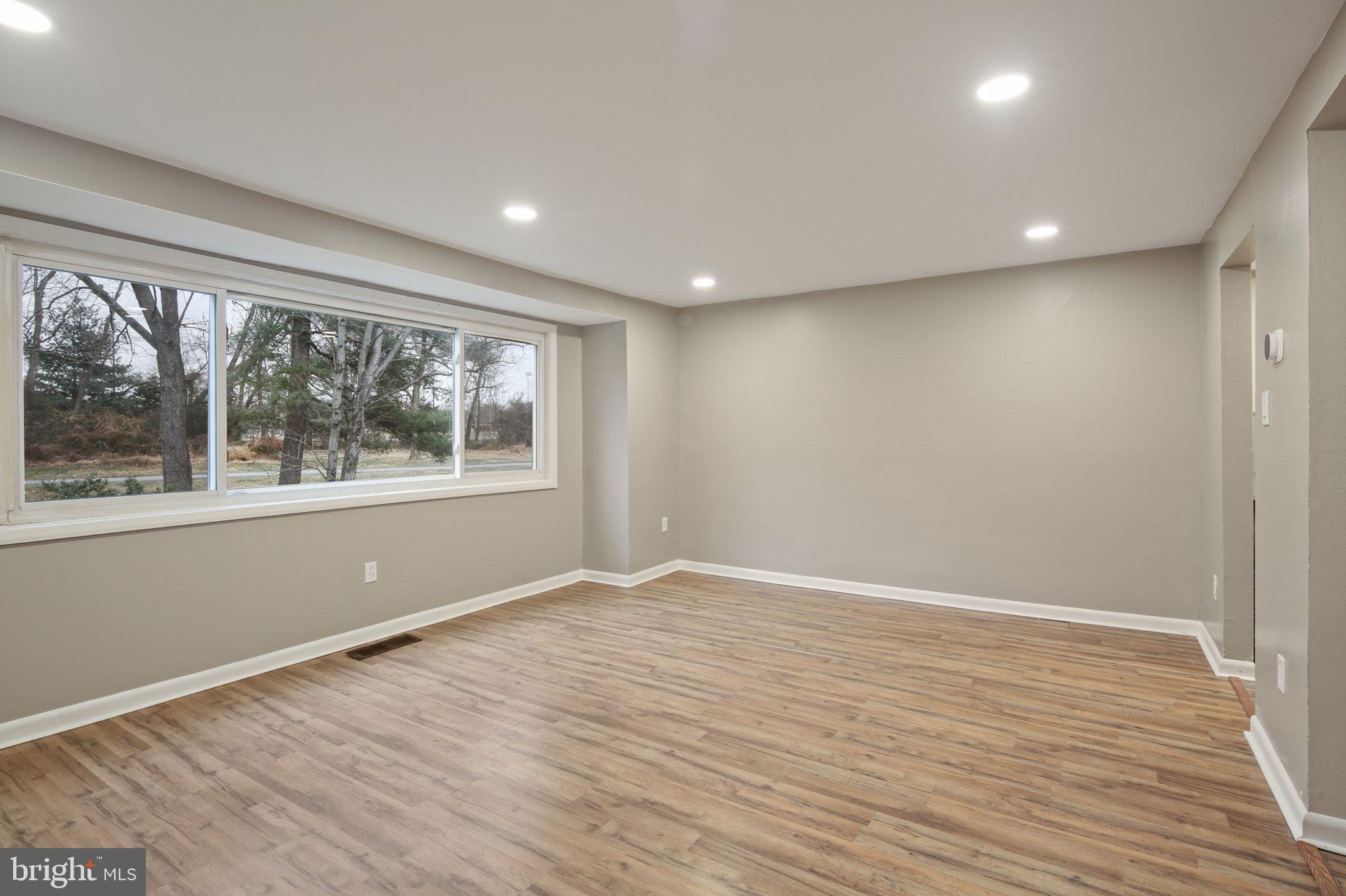 9432 Merryrest Road Columbia, MD 21045 - Photo 2 of 47 a view of empty room with wooden floor and fan