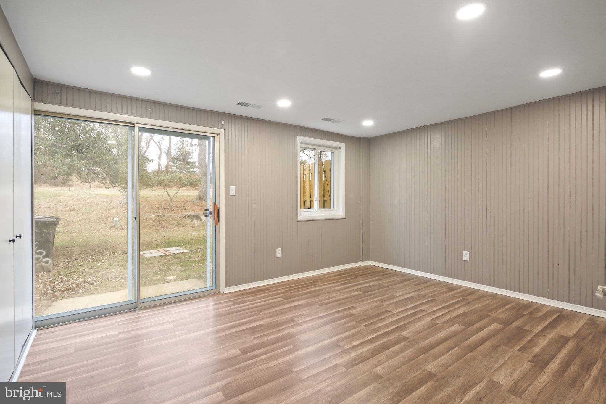 9432 Merryrest Road Columbia, MD 21045 - Photo 23 of 47 a view of empty room with wooden floor and fan