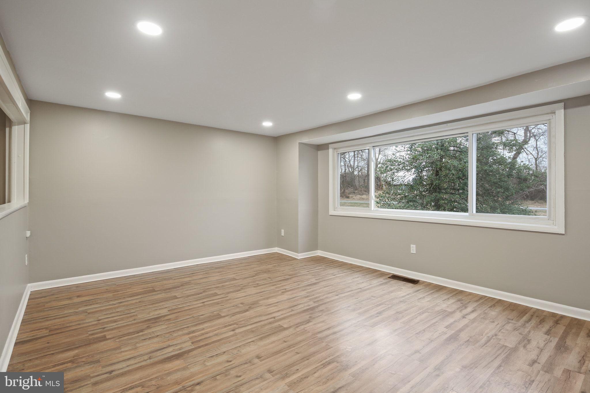 9432 Merryrest Road Columbia, MD 21045 - Photo 3 of 47 a view of an empty room with wooden floor and a window