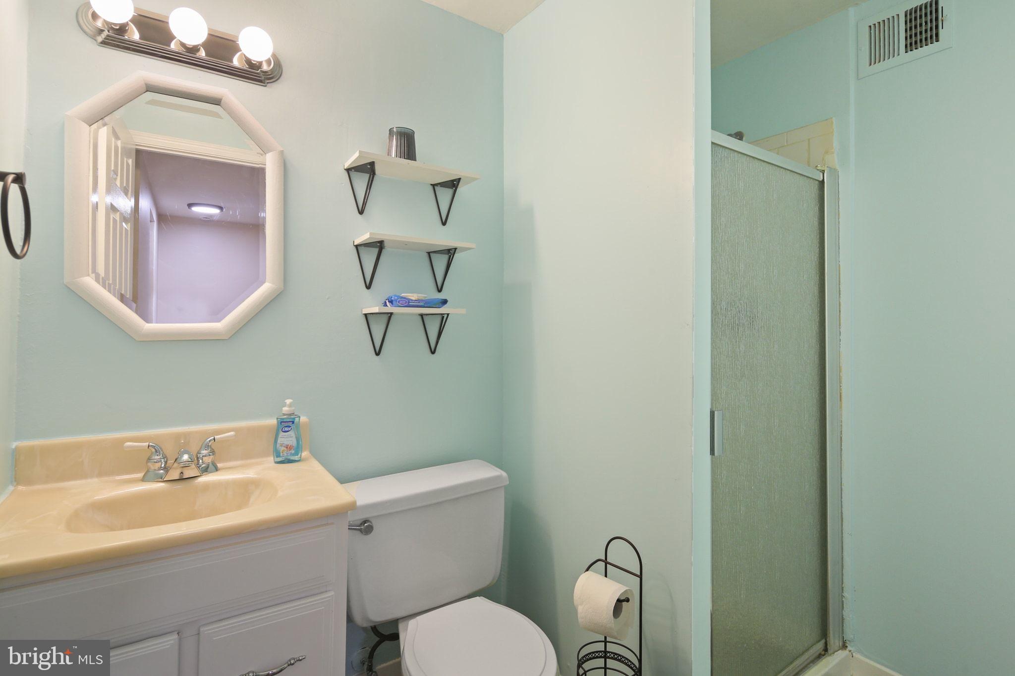 9432 Merryrest Road Columbia, MD 21045 - Photo 36 of 47 a bathroom with a toilet a sink and mirror