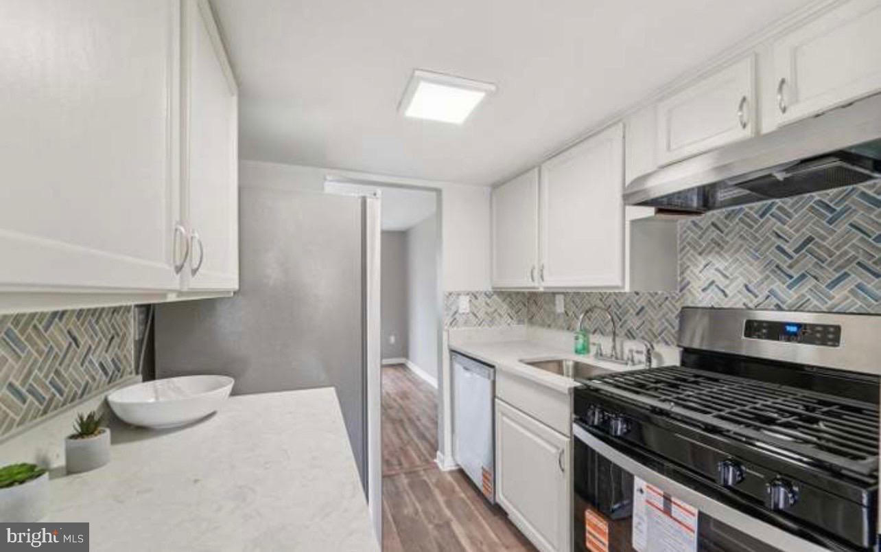 9432 Merryrest Road Columbia, MD 21045 - Photo 5 of 47 a kitchen with granite countertop a stove and a sink