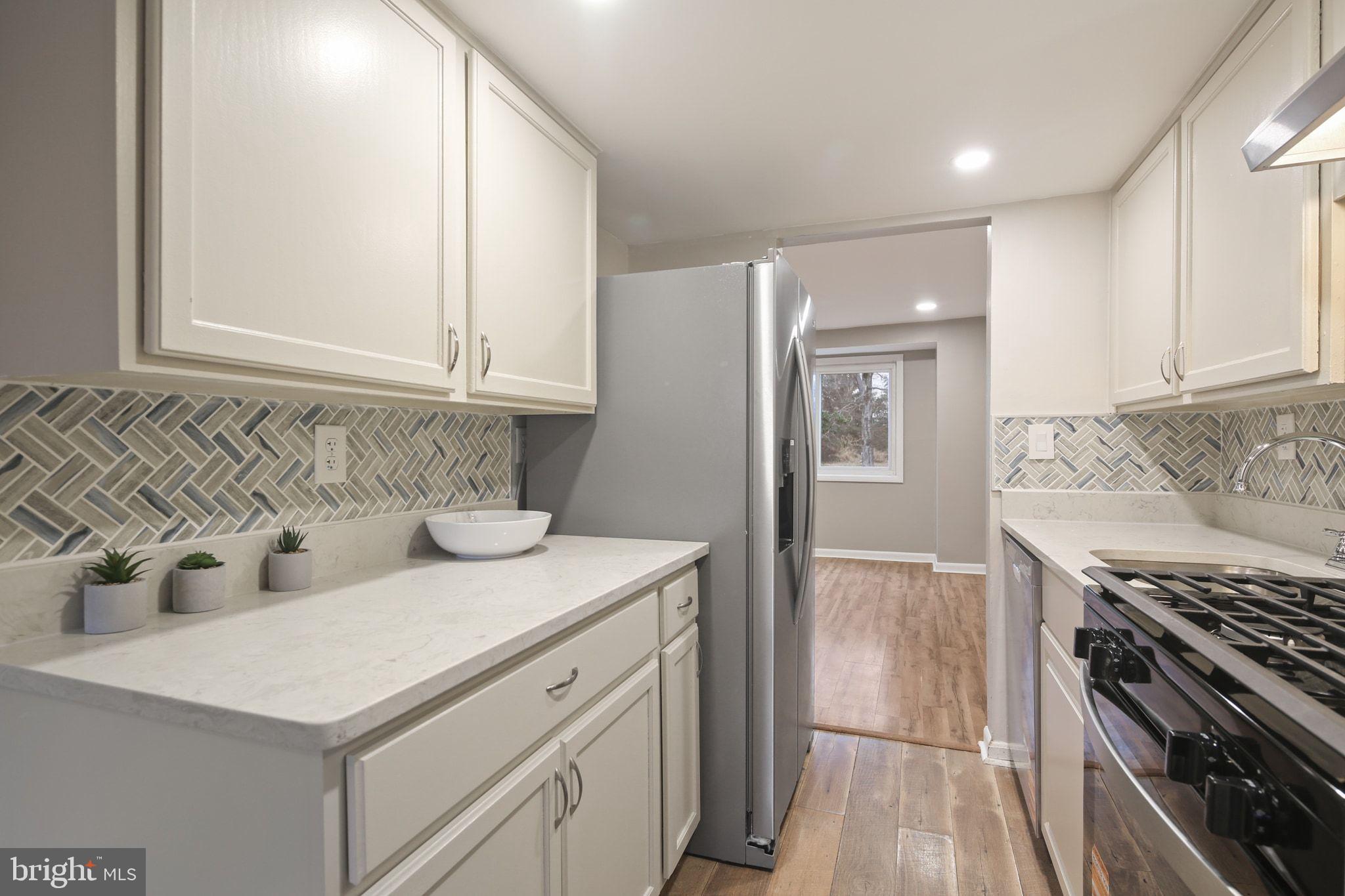 9432 Merryrest Road Columbia, MD 21045 - Photo 6 of 47 a kitchen with a sink stove and refrigerator