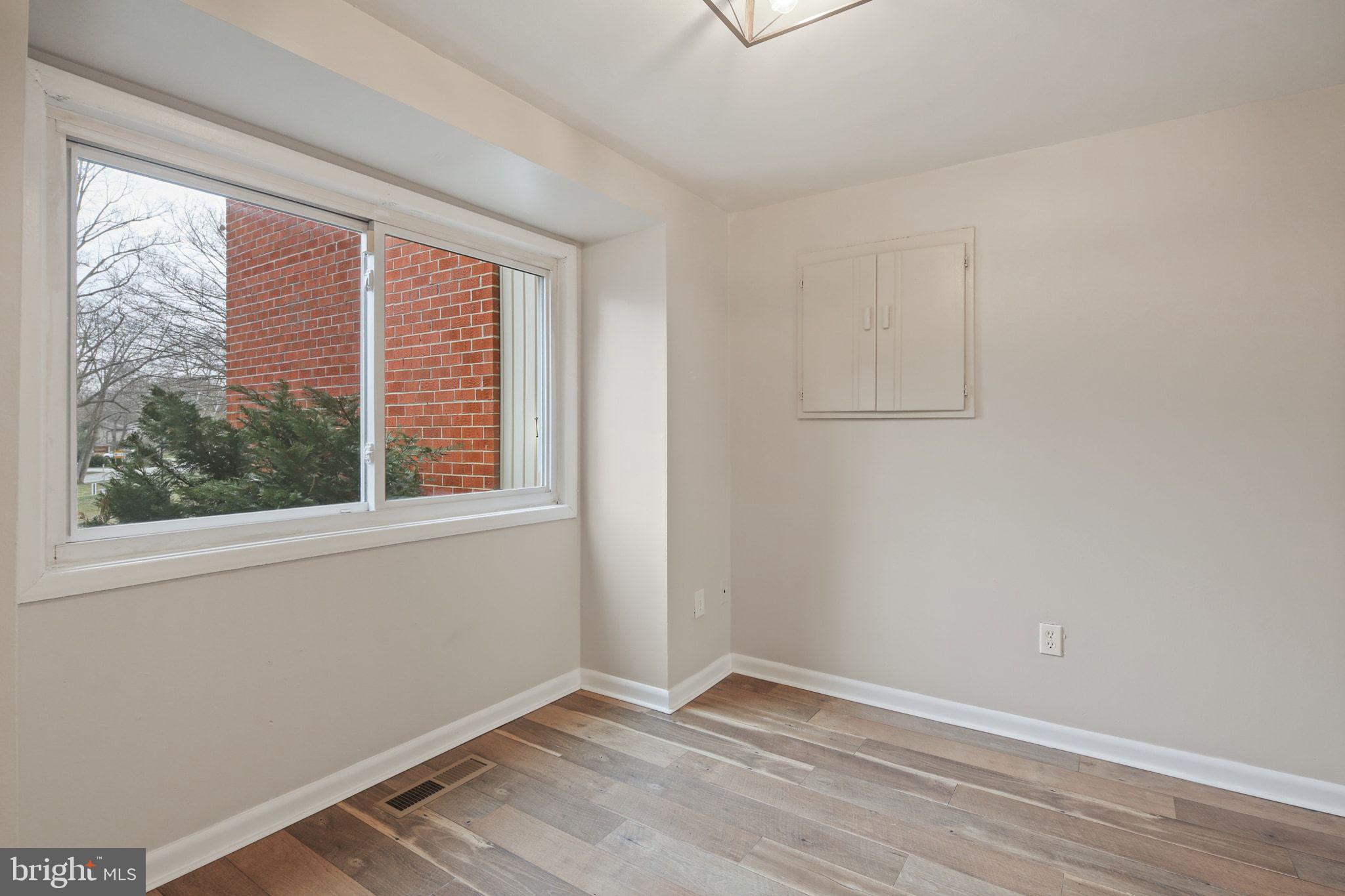 9432 Merryrest Road Columbia, MD 21045 - Photo 8 of 47 a view of an empty room with wooden floor and a window