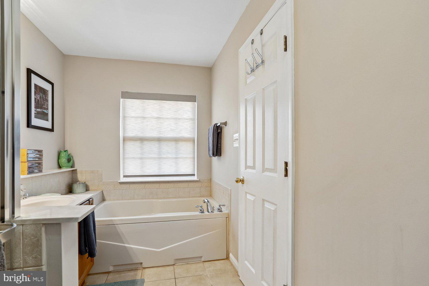 2530 Carrington Way Frederick, MD 21702 - Photo 20 of 38 a bathroom with a bathtub and a shower