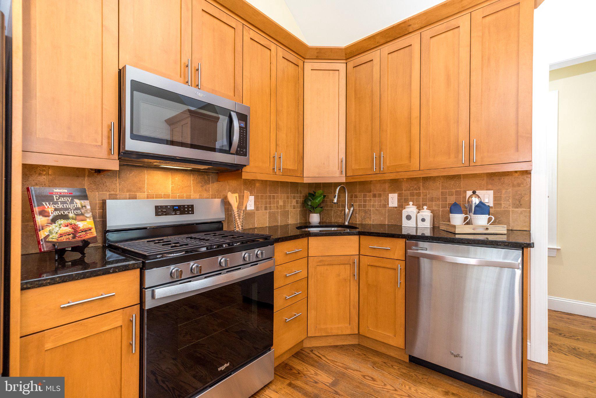 3645-57 Applebutter Road Fountainville, PA 18923 - Photo 18 of 98 a kitchen with stainless steel appliances granite countertop a stove a microwave and a sink
