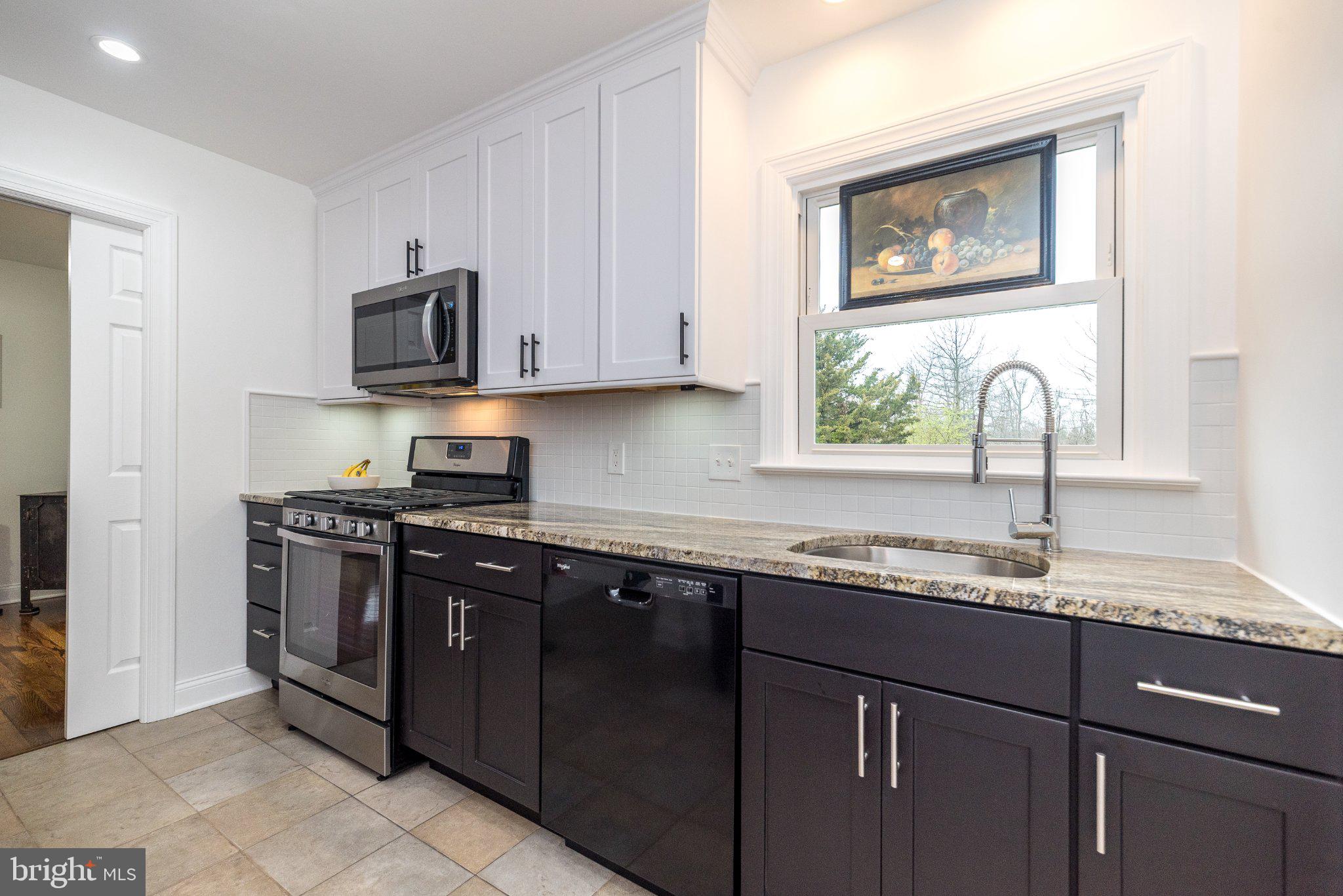 3645-57 Applebutter Road Fountainville, PA 18923 - Photo 61 of 98 a kitchen with stainless steel appliances granite countertop a sink stove and microwave