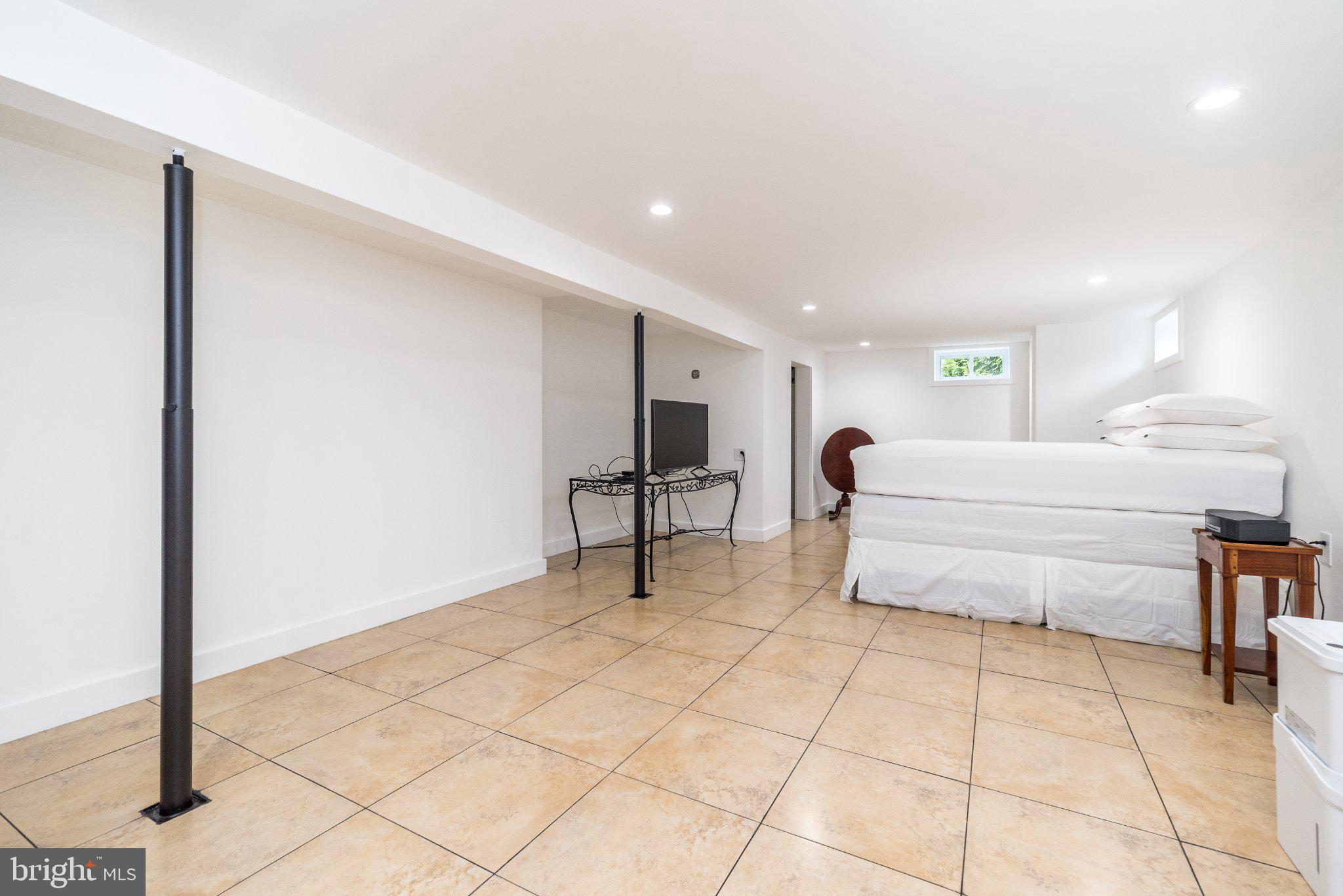 3645-57 Applebutter Road Fountainville, PA 18923 - Photo 75 of 98 a spacious bedroom with a bed and a table in it