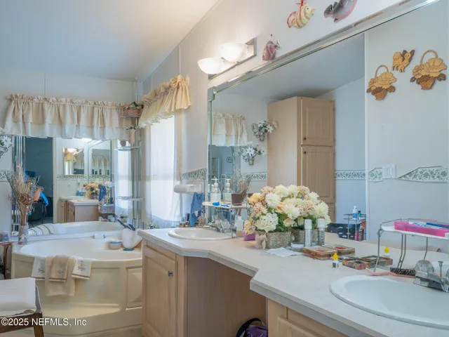 a bathroom with a sink a large mirror and a shower